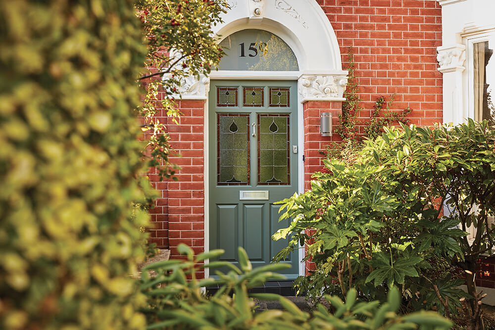 Green Victorian style front door. 